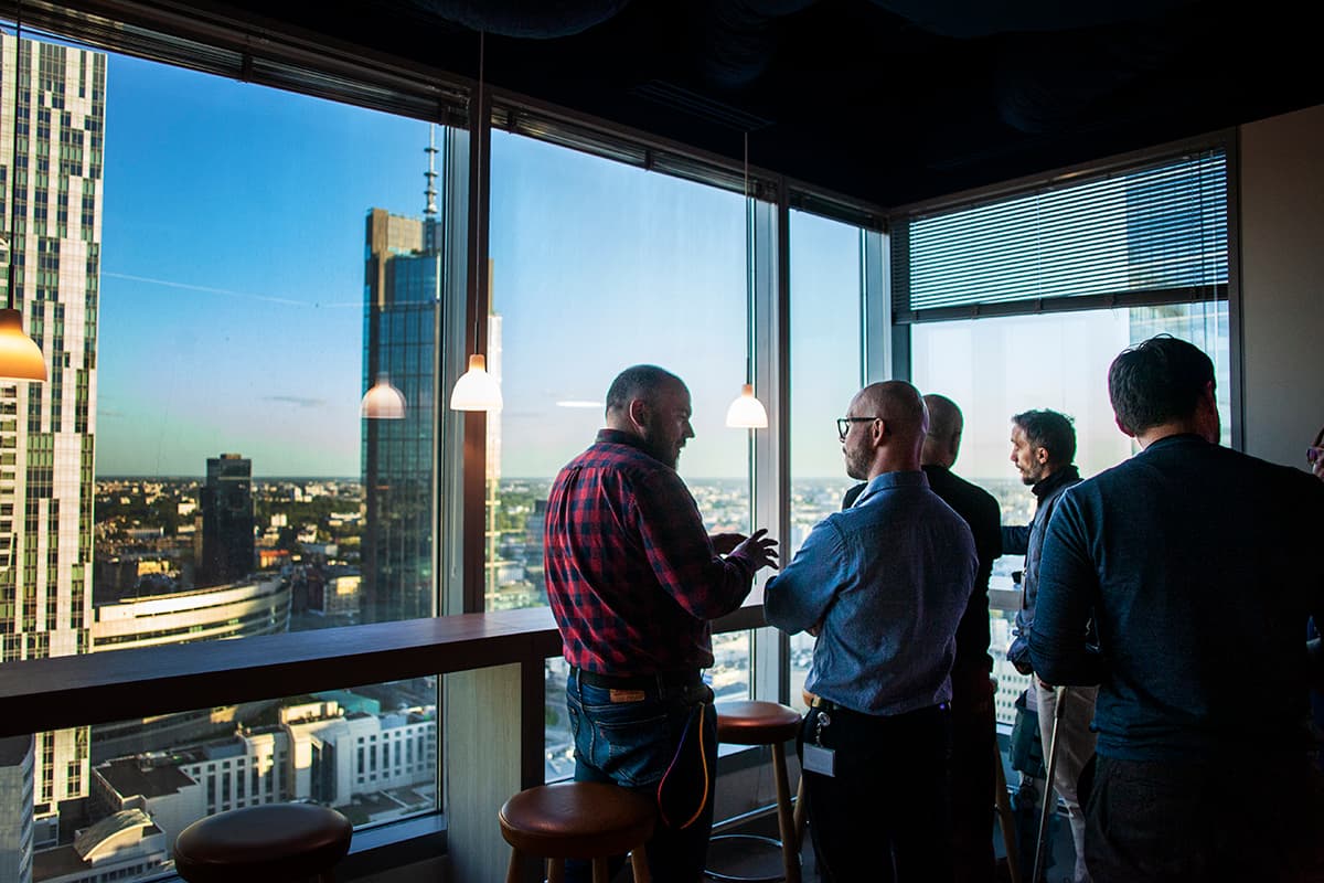 zt1 partners talking during a meeting in an office tower overlooking Warsaw
